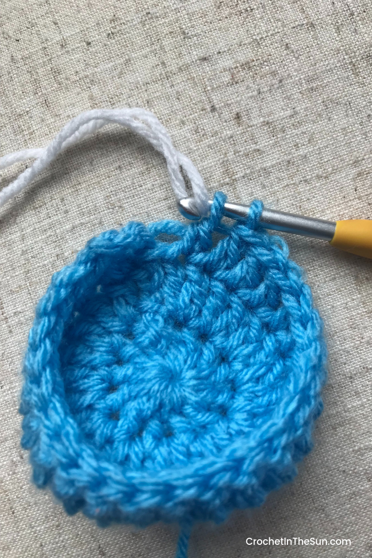 Get ready to change colors in crochet. On your last yarn over, use the NEW yarn color and pull through