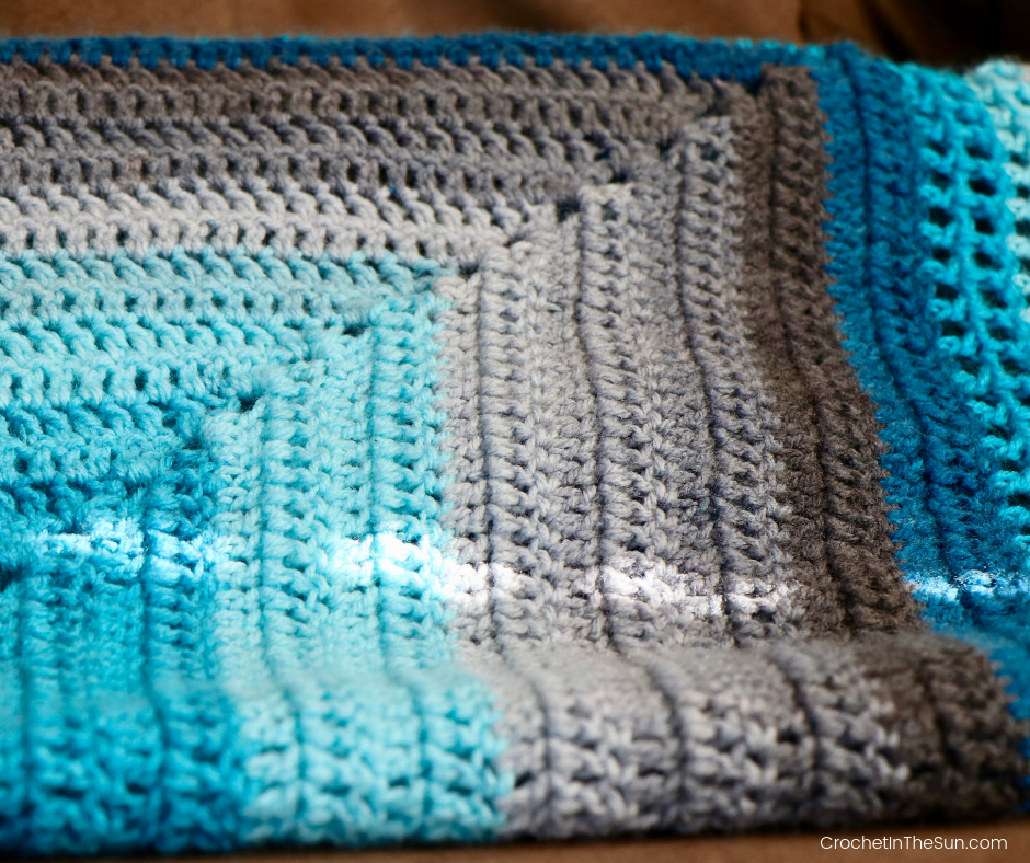 Free crochet blanket pattern using Lion Brand Mandala. This is an easy and beginner friendly crochet blanket. All 1 stitch! #crochet #lionbrandmandala #crochetblanket