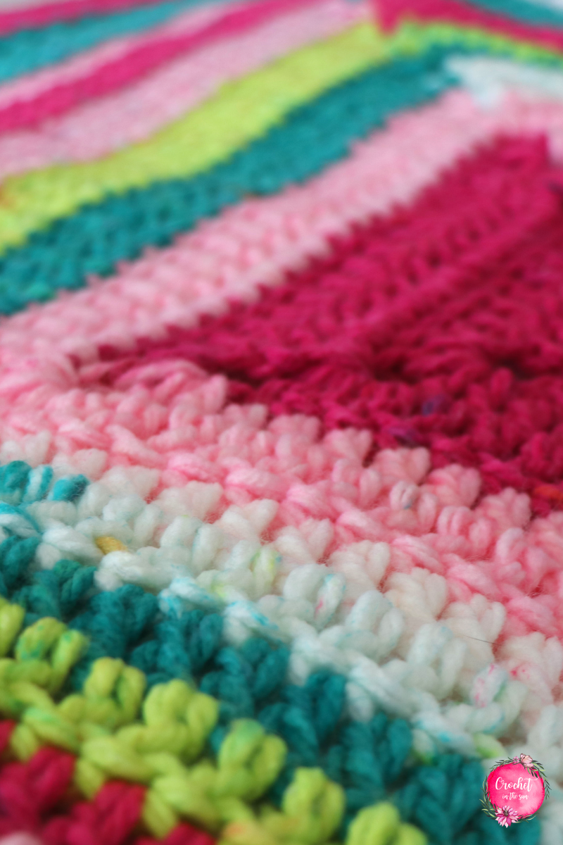 Details of the Lion Brand Whitby Crochet Baby Blanket pattern. This free crochet pattern is easy and a great project for beginners due to the repetitive pattern and super bulky yarn. #crochetblanket #crochet