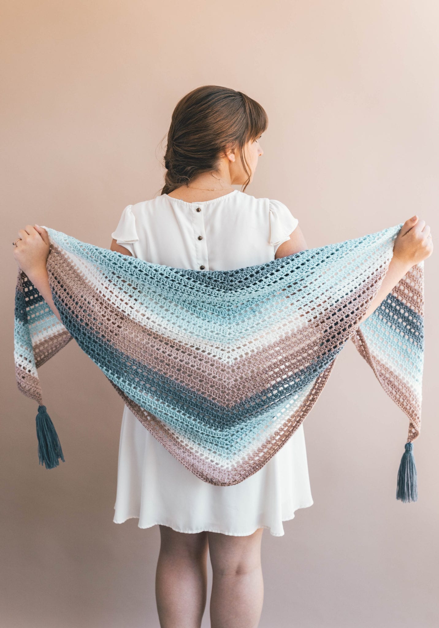 What can I crochet with self-striping yarn? This beautiful shawl looks wonderful in Lion Brand Mandala baby yarn doesn't it?! This pattern would also look great using Scheepjes whirl! #crochet #crochetwrap #crochetshawl