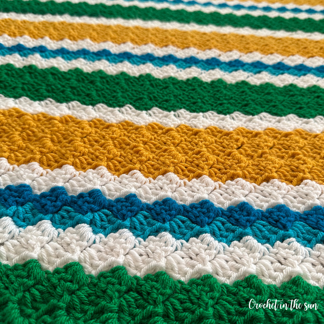 Easy crochet blanket pattern for soccer fans, customizable corner-to-corner design in bold colors.