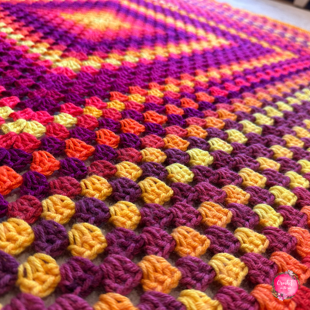 Beautiful crochet blanket with bright striped granny squares - free and beginner-friendly pattern