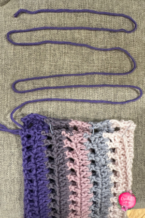 Shows how you leave a long string of the last color so you can use that to attach the 2 sides