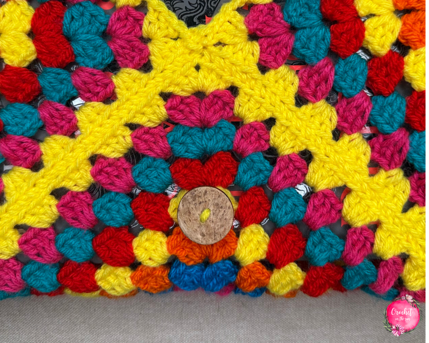 Attach a button to your crochet book  sleeve so you can secure it closed.